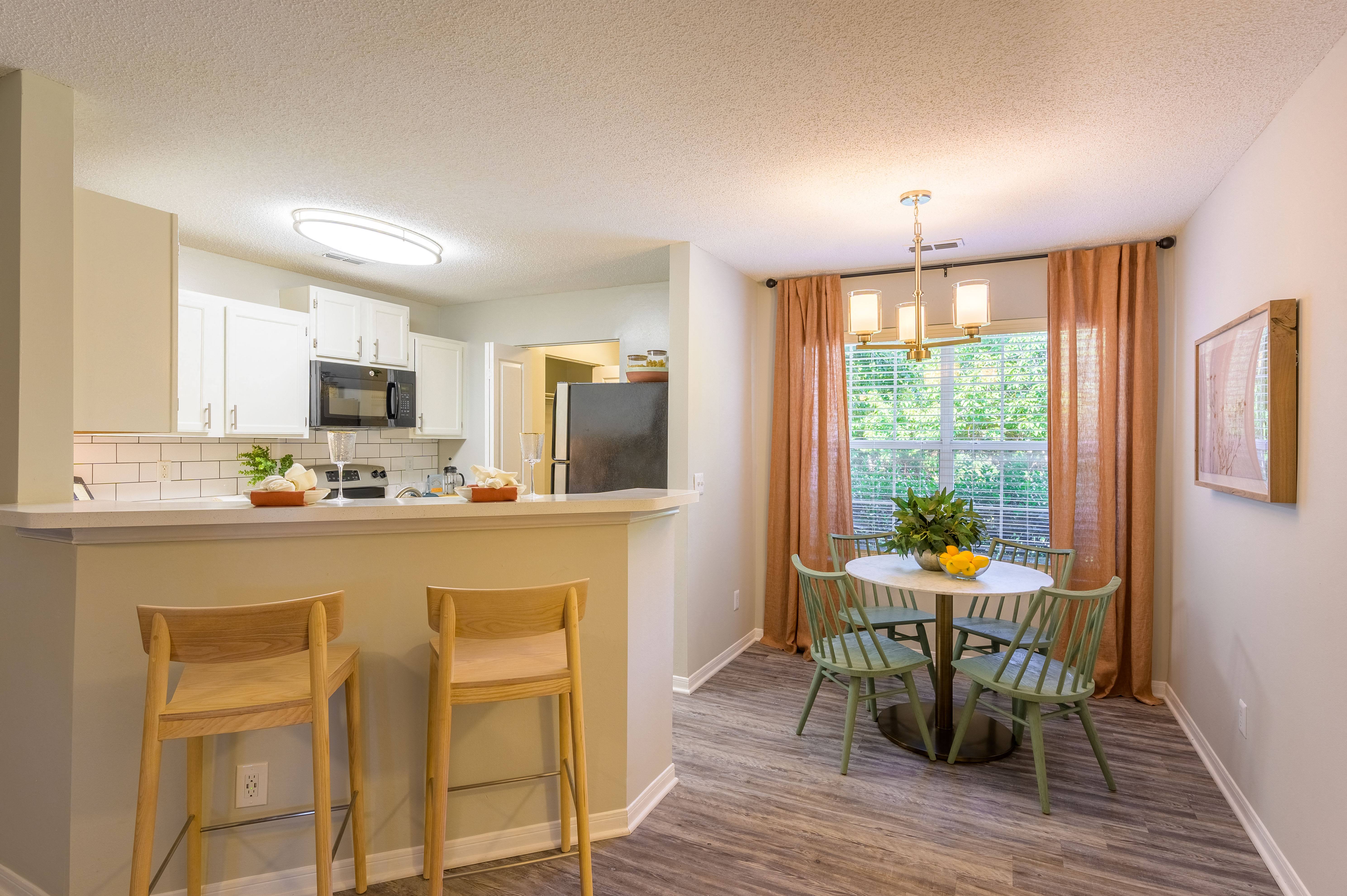 an open kitchen and dining area with a table and chairs